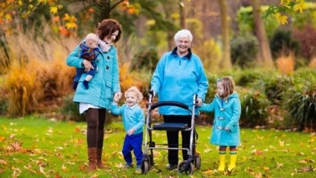 Grandmother with daughter and grand daughters, walking to the garden with her walker