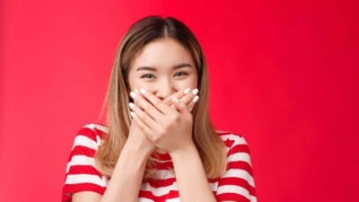 Girl giggling and covering her mouth