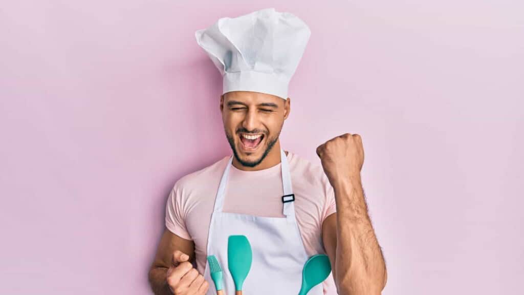 Man in chef's hat celebrating