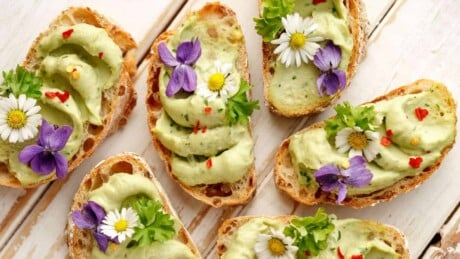 Toast with avocado paste and edible flowers