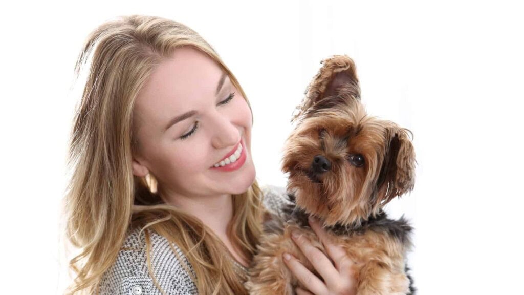 Woman smiling and holding her dog