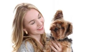Woman smiling and holding her dog