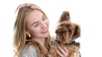 Woman smiling and holding her dog