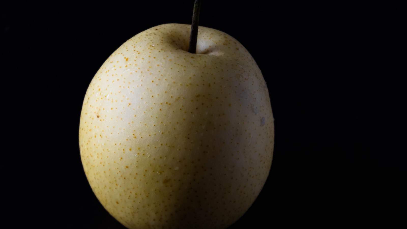 Honeysweet pear isolated in black