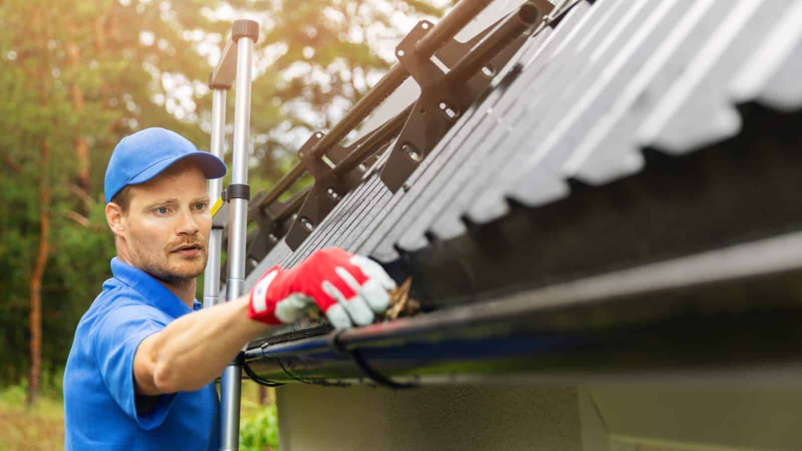 Man cleaning gutter