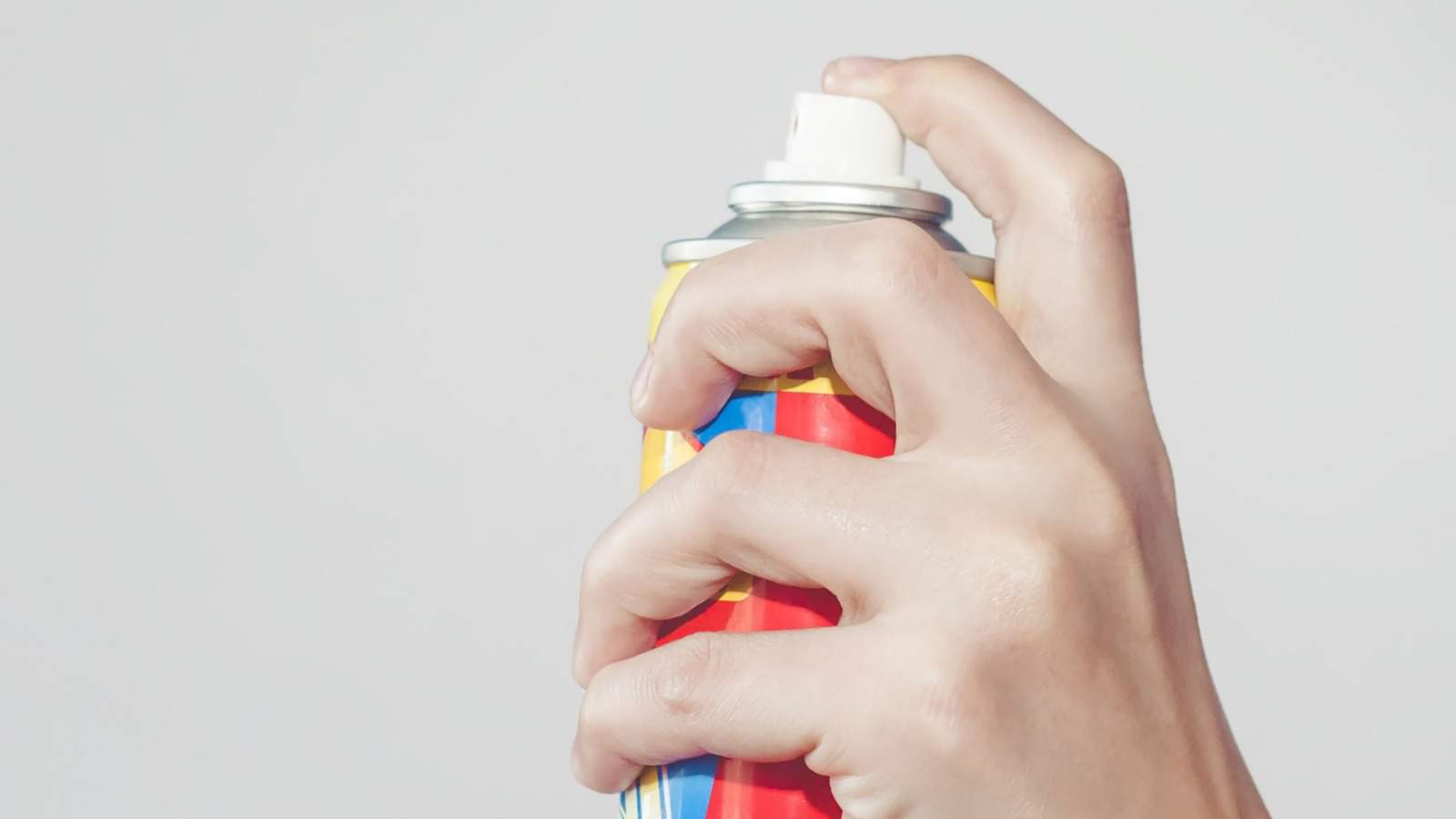 Hand holding a pesticide spray