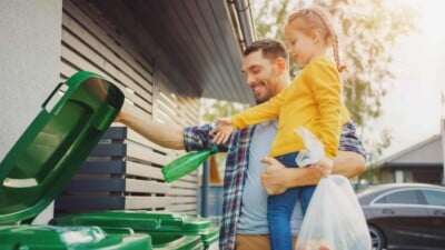 Father and daughter recycling trash