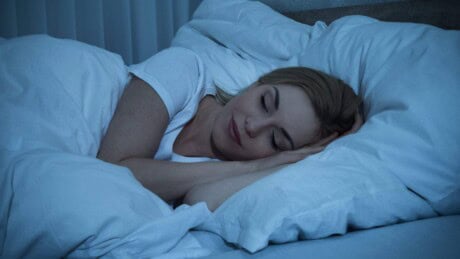 Young Woman With Blanket Sleeping In Bed.