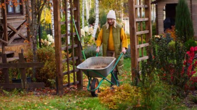 Woman preparing garden for winter