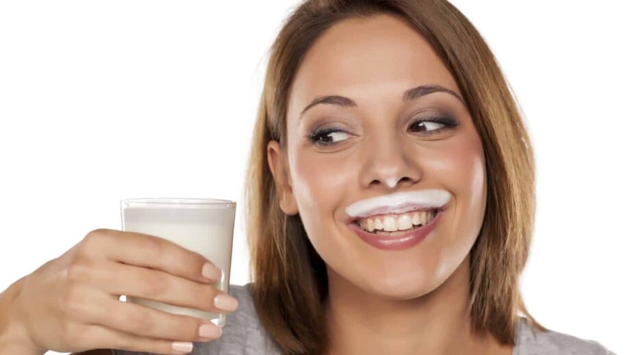 Woman with an almond milk moustache