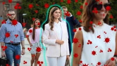 Young healthy woman with an antiviral force-field surrounded by viruses in crowd
