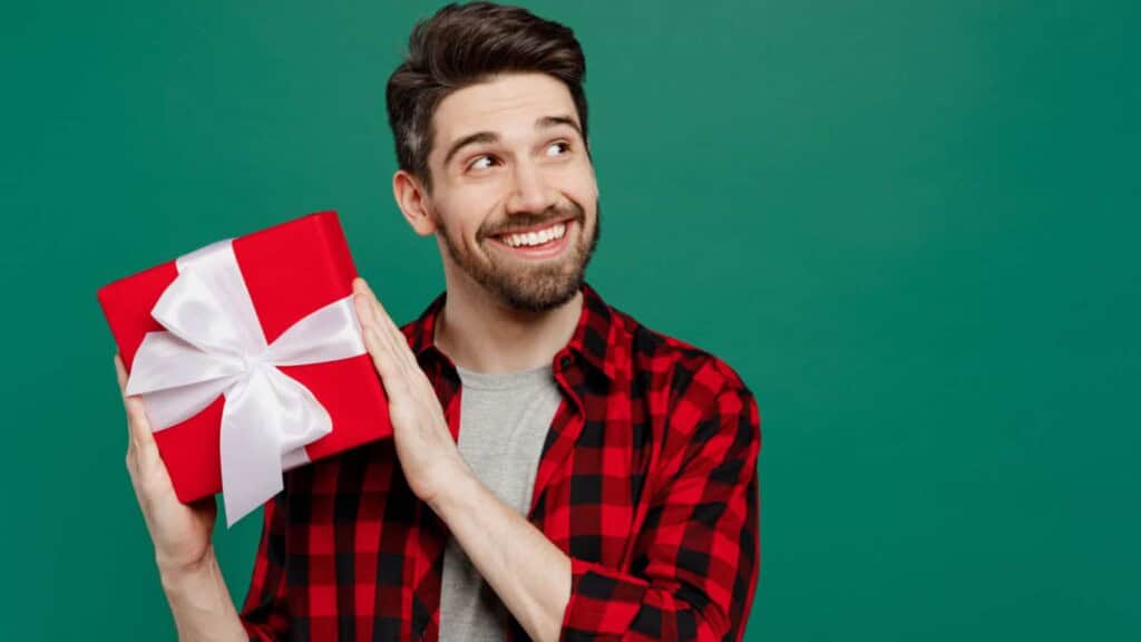 Man smiling with a gift