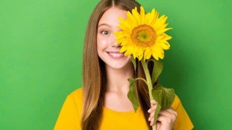 Woman holding sunflower