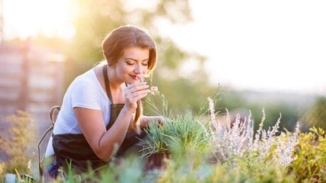 Gardener smelling flower