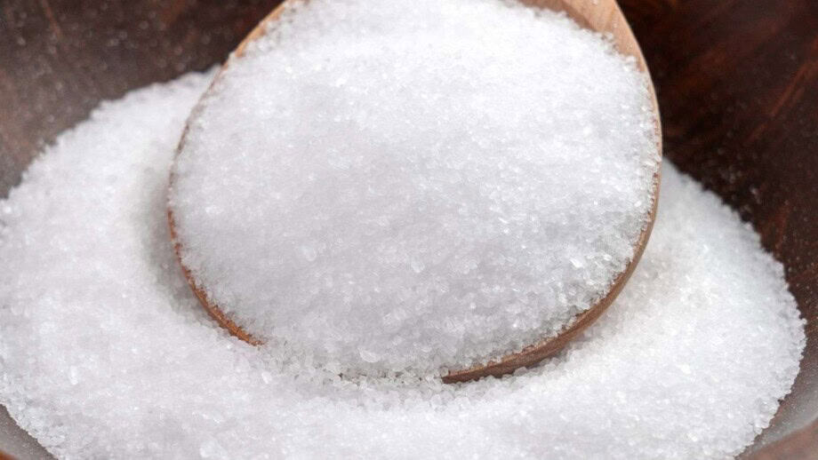 Close up view of Epsom salt crystals in a wooden spoon