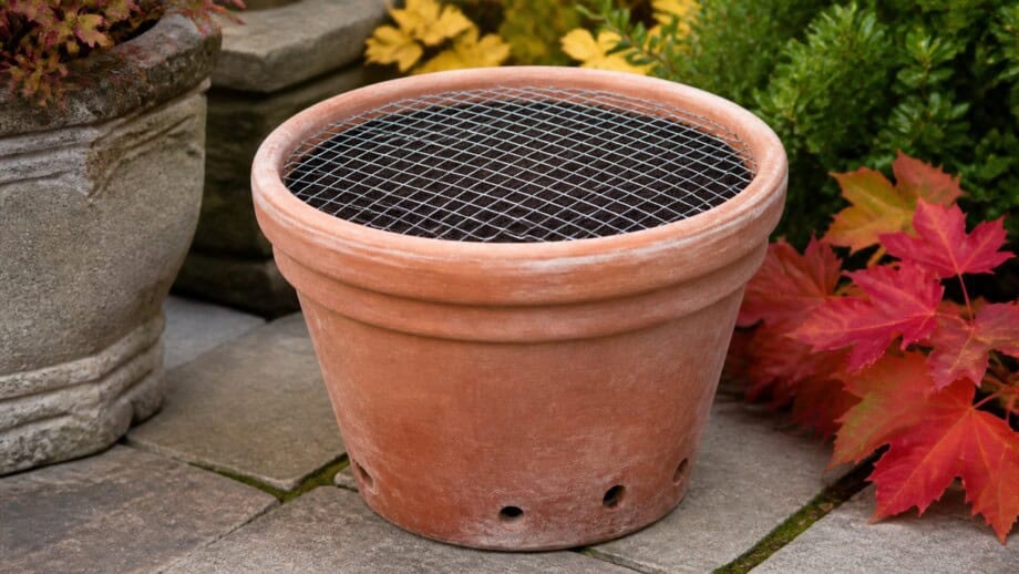 Terracotta bulb planter with a round wire mesh disk tucked under the pot rim.